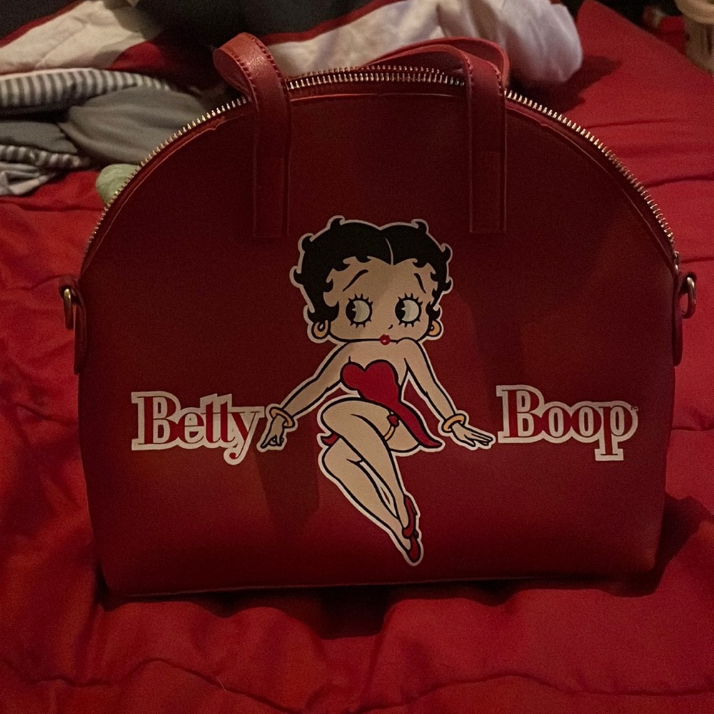 Red Betty Boop hand/shoulder bag with adjustable strap attachment.